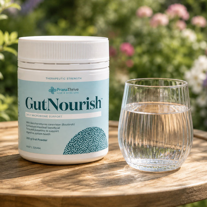 GutNourish 300 g tub beside a prepared glass on a wooden table