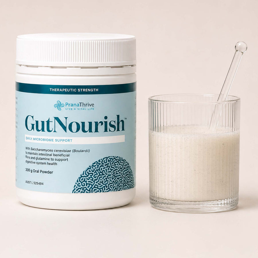 A prepared glass of GutNourish beside the tub